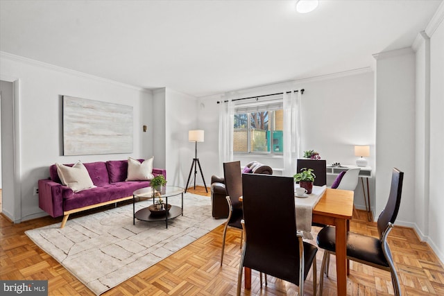 dining space featuring crown molding and light parquet floors