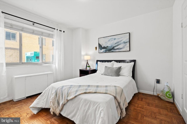 bedroom with parquet flooring and radiator heating unit