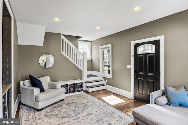 entrance foyer with stairs, recessed lighting, wood finished floors, and baseboards