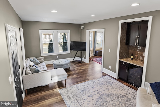 living room with recessed lighting, visible vents, dark wood finished floors, and baseboards