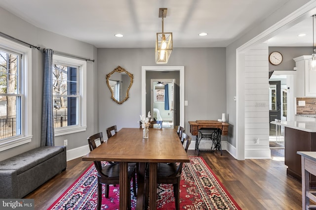 dining space with baseboards, dark wood-style flooring, and recessed lighting