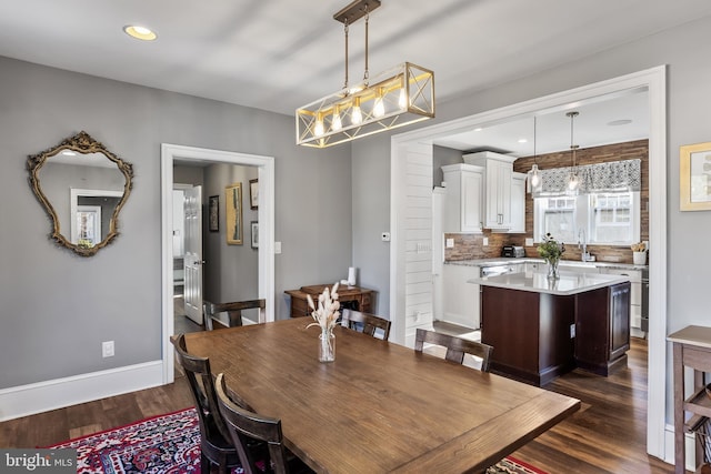 dining space with baseboards, dark wood-style flooring, and recessed lighting