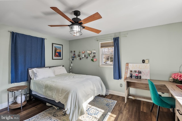 bedroom featuring dark wood-type flooring, a ceiling fan, and baseboards