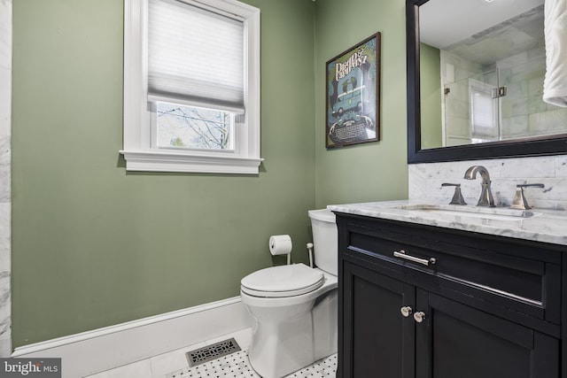 bathroom with visible vents, decorative backsplash, toilet, vanity, and a shower stall