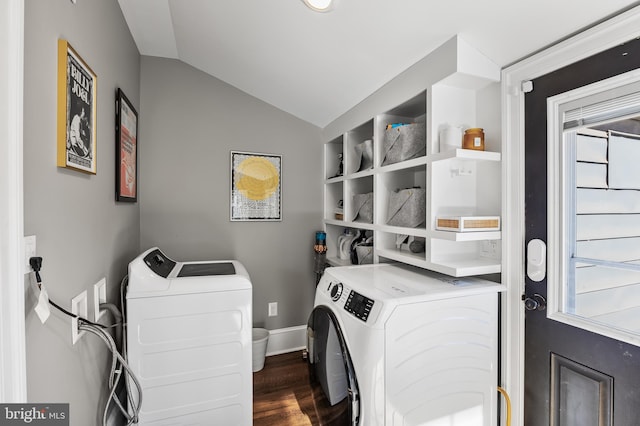 clothes washing area with a healthy amount of sunlight, laundry area, washing machine and dryer, and dark wood-style floors