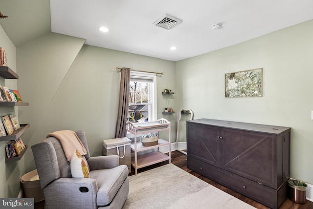 living area featuring visible vents, dark wood finished floors, and recessed lighting