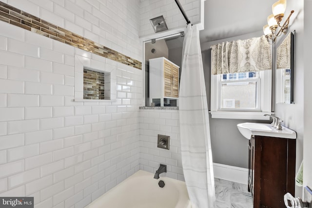 full bathroom featuring marble finish floor, shower / bathtub combination with curtain, baseboards, and vanity