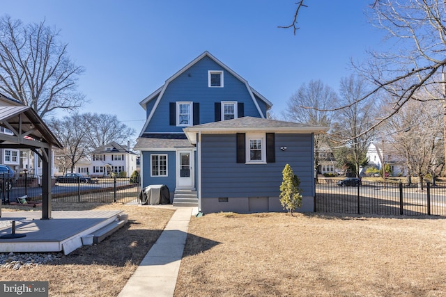 view of front facade featuring crawl space, a shingled roof, fence, and a gambrel roof