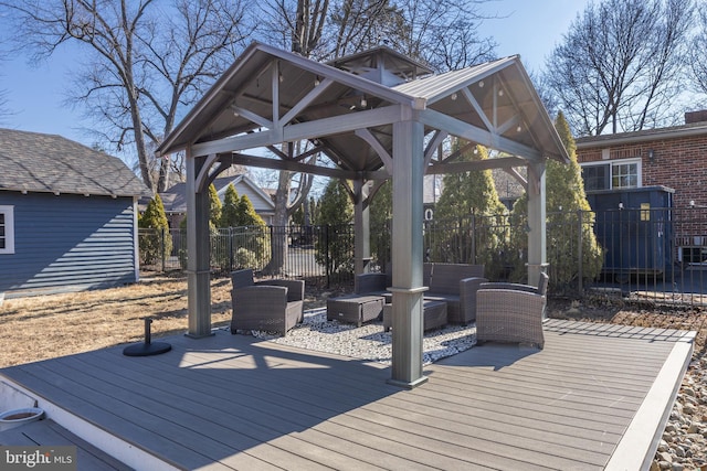 wooden terrace with fence, an outdoor living space, and a gazebo