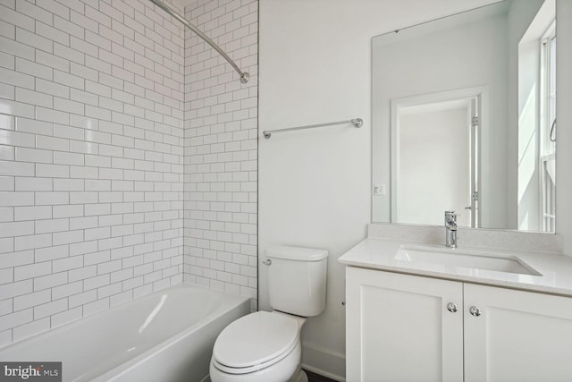 full bathroom featuring toilet, vanity, and tiled shower / bath