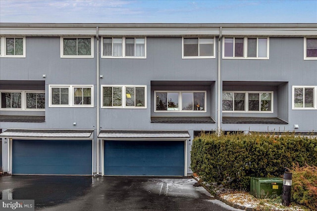 rear view of house featuring a garage