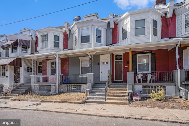 townhome / multi-family property with a porch