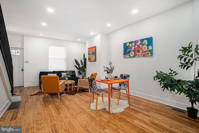 office space with light wood-type flooring, visible vents, and recessed lighting