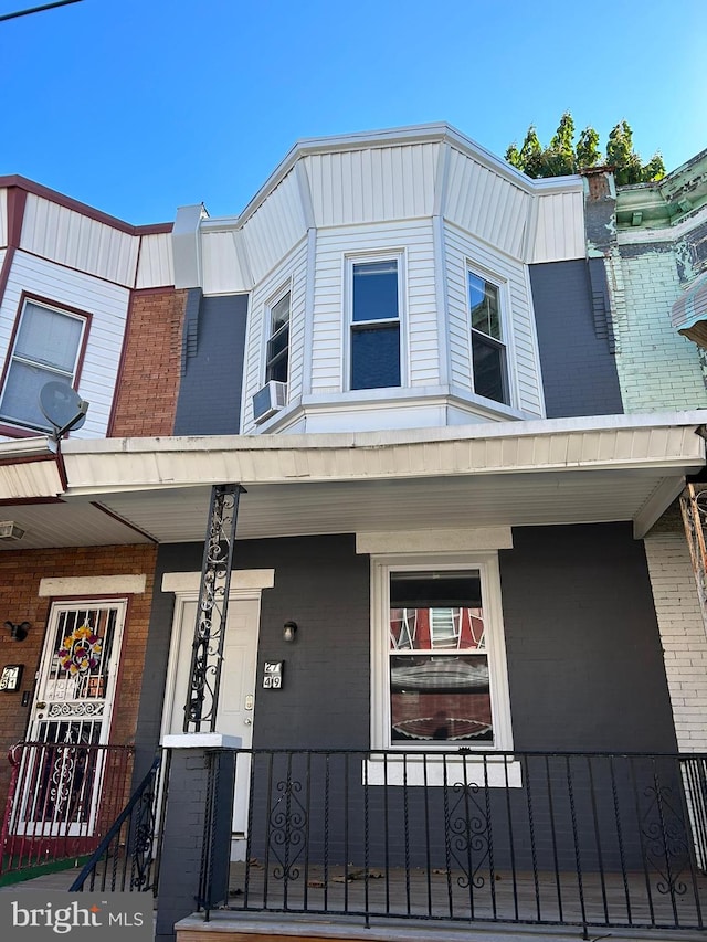 view of front facade with cooling unit and covered porch