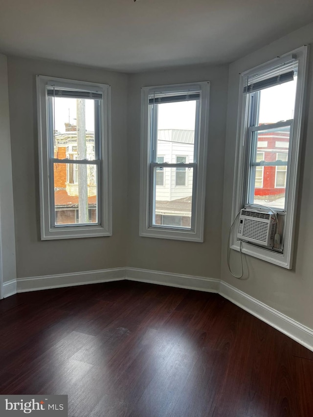 unfurnished room with dark wood-type flooring and cooling unit