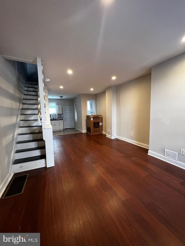 basement with dark hardwood / wood-style floors