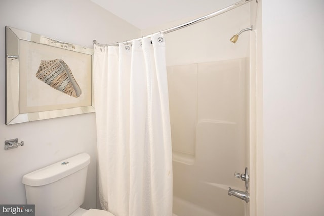 bathroom with shower / bath combination with curtain and toilet