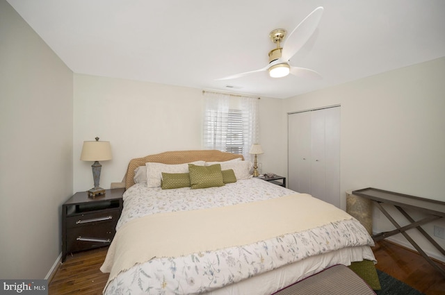 bedroom featuring a closet, dark hardwood / wood-style floors, and ceiling fan