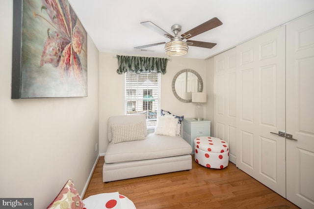 sitting room featuring ceiling fan and light hardwood / wood-style flooring