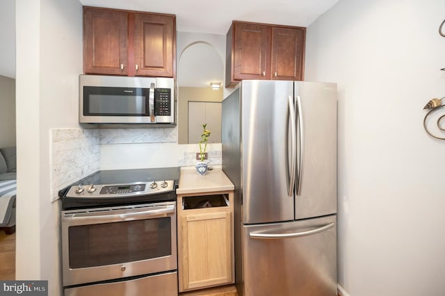 kitchen with appliances with stainless steel finishes and decorative backsplash