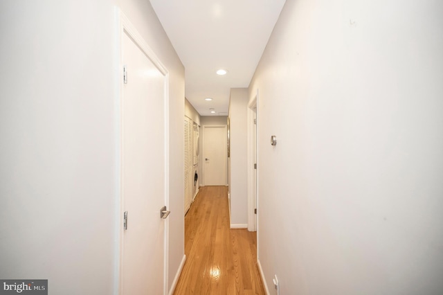 hallway with light hardwood / wood-style floors