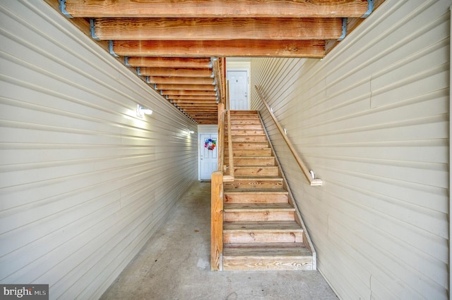 stairs featuring concrete floors