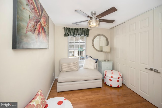 sitting room featuring ceiling fan and light hardwood / wood-style floors