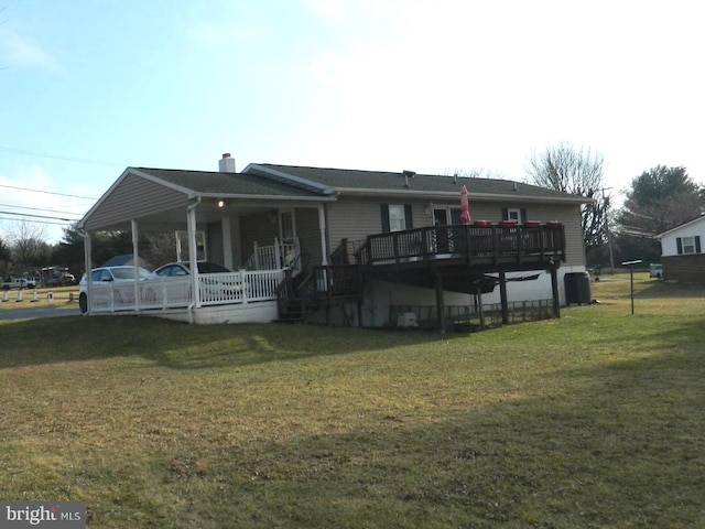 view of front of house featuring central AC, covered porch, and a front yard