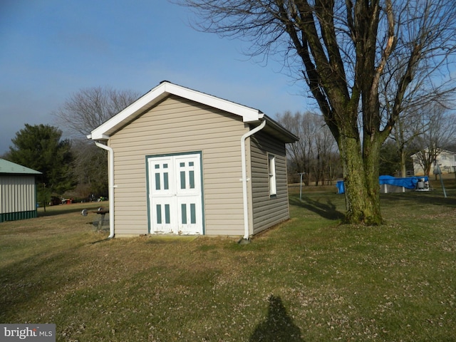 view of outbuilding with a lawn