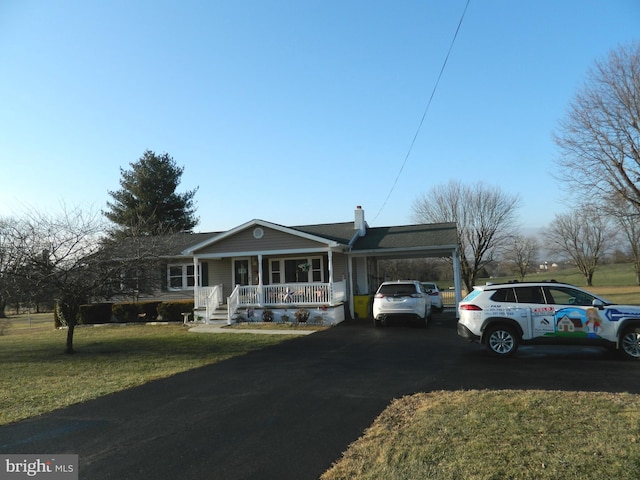 single story home with a carport, a front yard, and covered porch