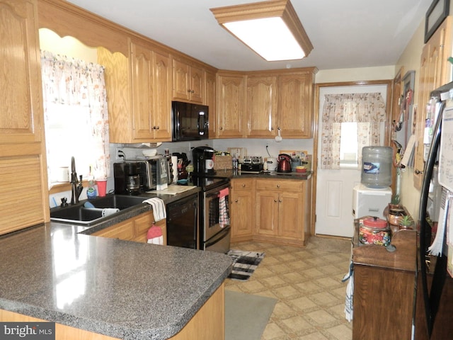 kitchen featuring sink, black appliances, and kitchen peninsula