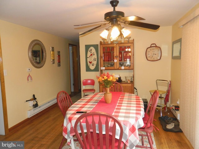 dining room with dark wood-type flooring, ceiling fan, and baseboard heating