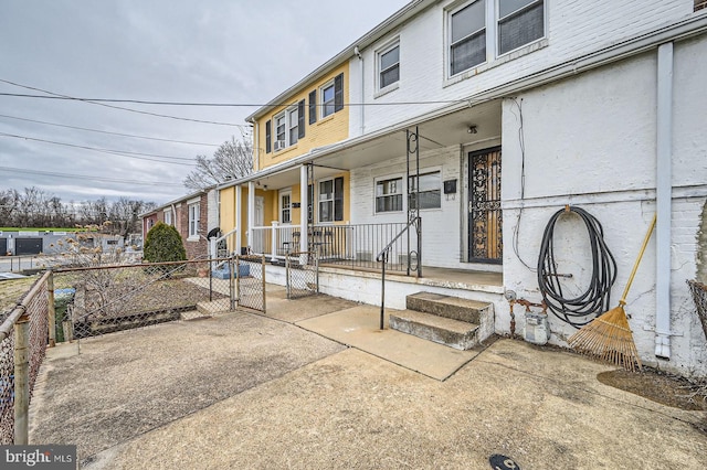 exterior space with a porch, a gate, and fence