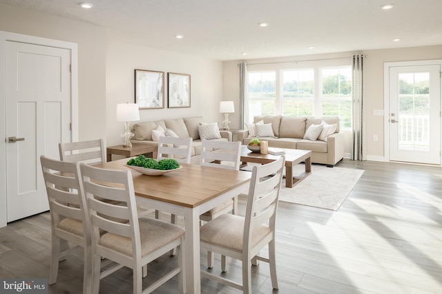 dining area with recessed lighting, baseboards, and wood finished floors