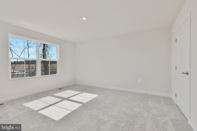 spare room featuring visible vents, baseboards, and carpet floors