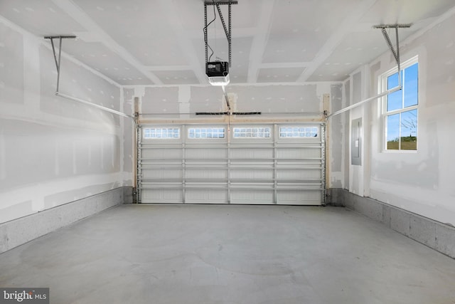 garage featuring electric panel and a garage door opener