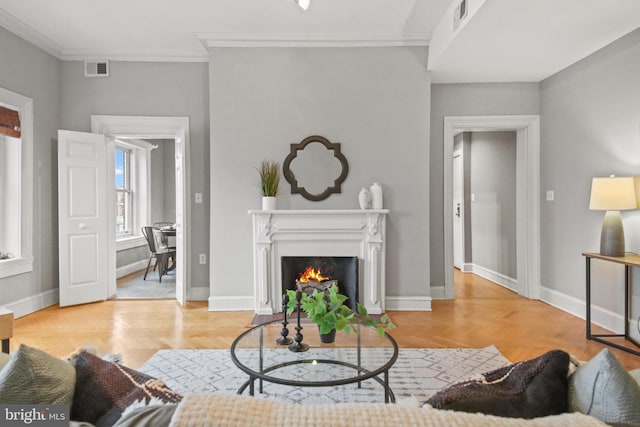 living room with ornamental molding and light hardwood / wood-style floors