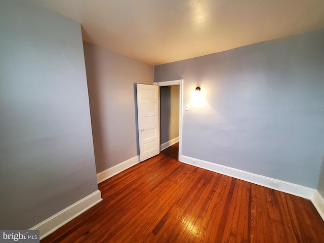 spare room with dark wood-type flooring