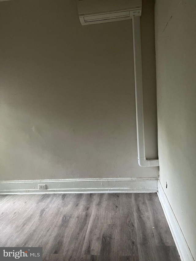 room details with wood-type flooring and a wall mounted AC