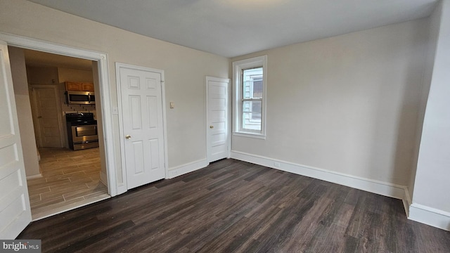 unfurnished bedroom with dark hardwood / wood-style floors