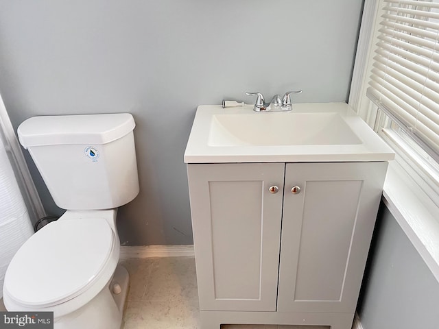 bathroom featuring tile patterned floors, vanity, and toilet