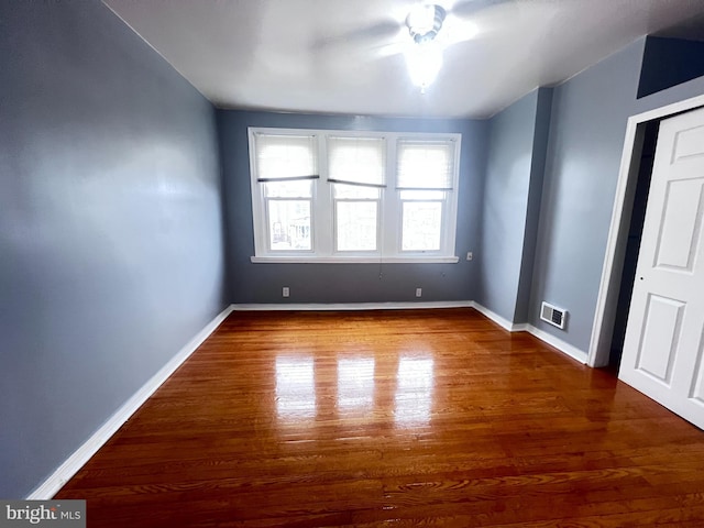 unfurnished room featuring dark hardwood / wood-style floors