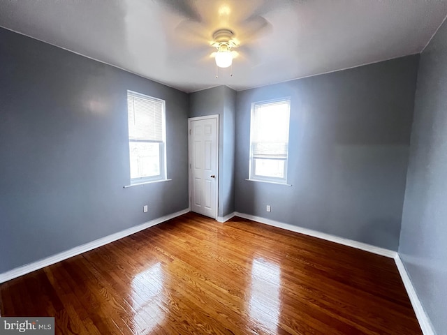 unfurnished bedroom with hardwood / wood-style floors, a closet, and ceiling fan