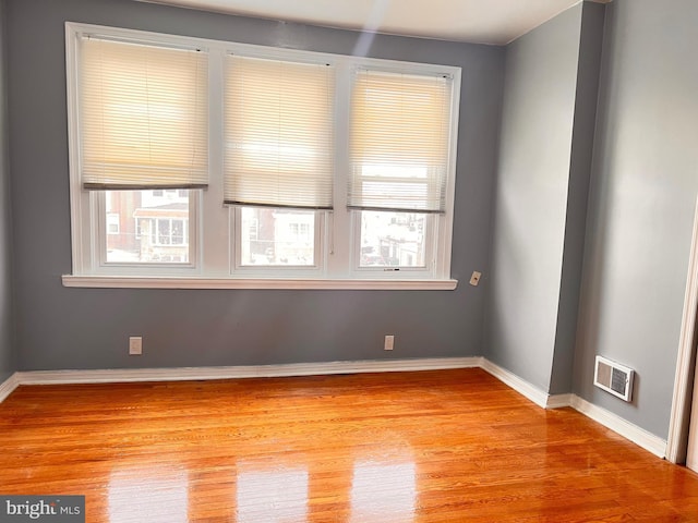 spare room with light hardwood / wood-style flooring