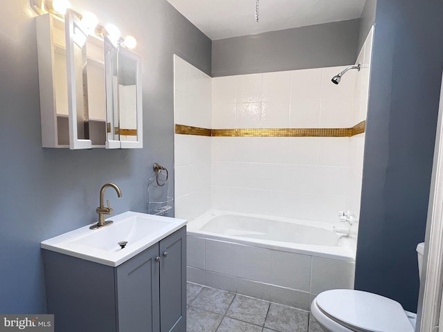 full bathroom with vanity, toilet, tiled shower / bath combo, and tile patterned flooring