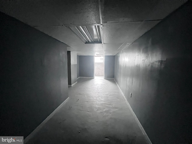 hall featuring concrete flooring