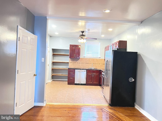 kitchen with ceiling fan, stainless steel appliances, light hardwood / wood-style floors, and sink