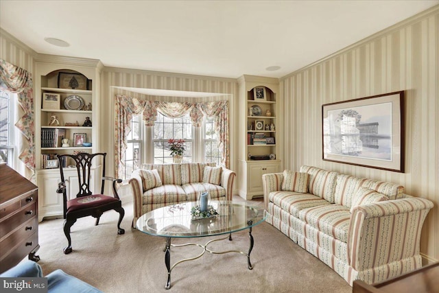 living area featuring built in features, carpet, and wallpapered walls