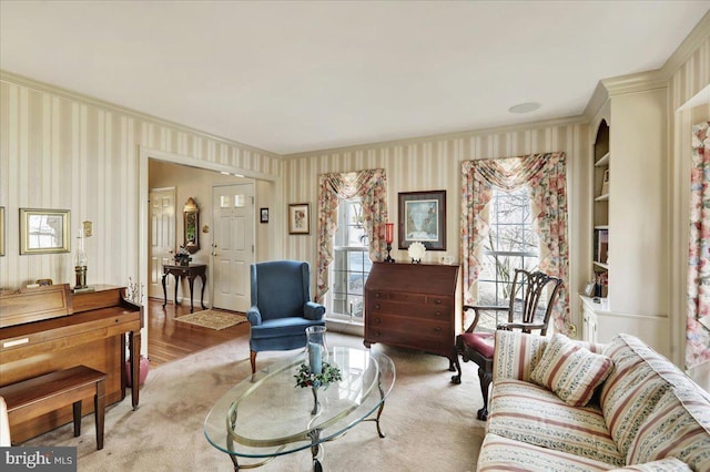 living room with crown molding and wallpapered walls