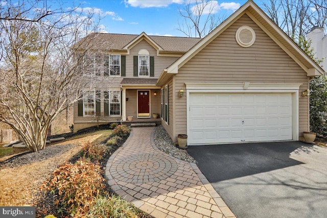 view of front of house with a garage and aphalt driveway